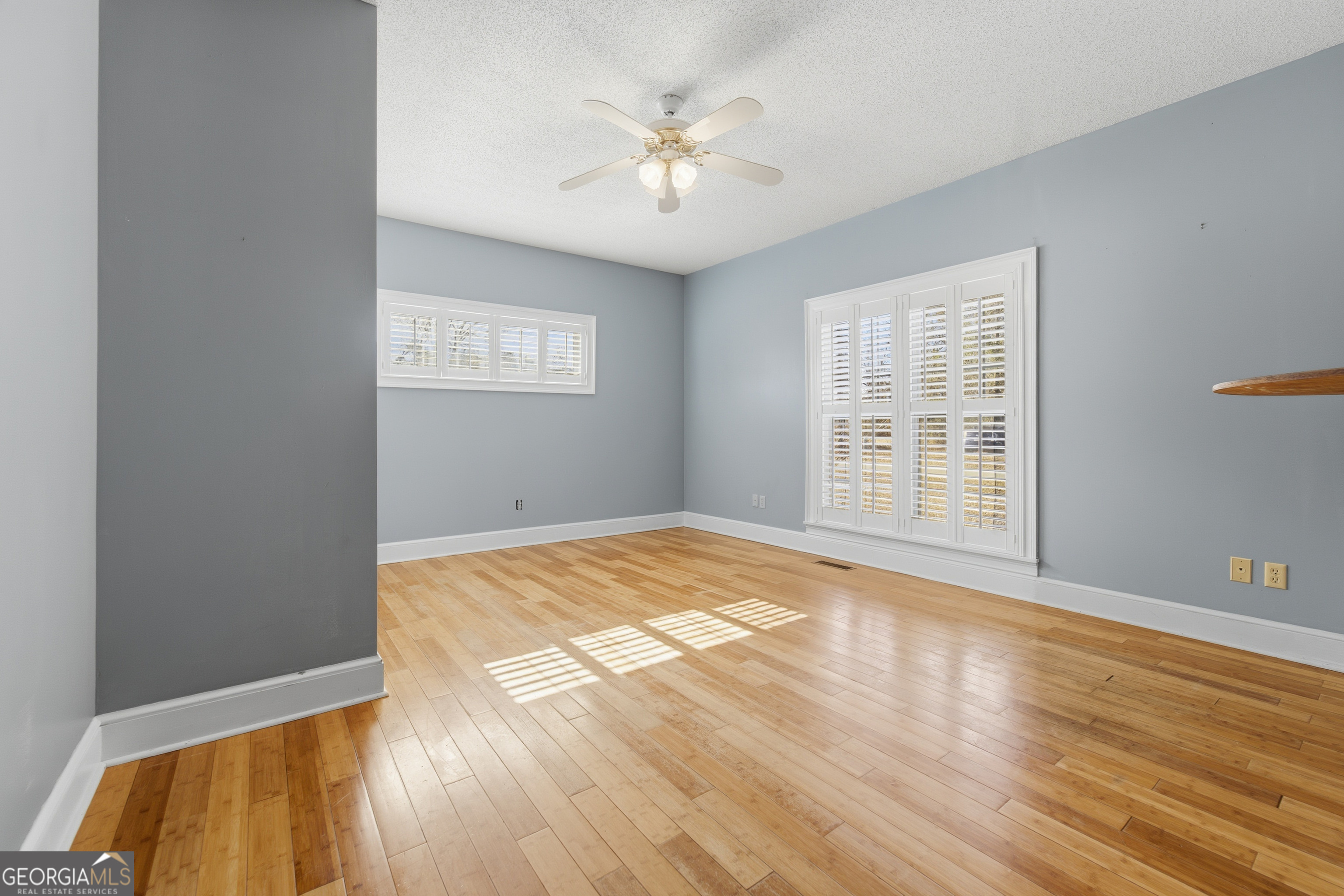 134 Patrick Street Swainsboro, GA 30401 - Photo 49 of 57 an empty room with wooden floor and windows