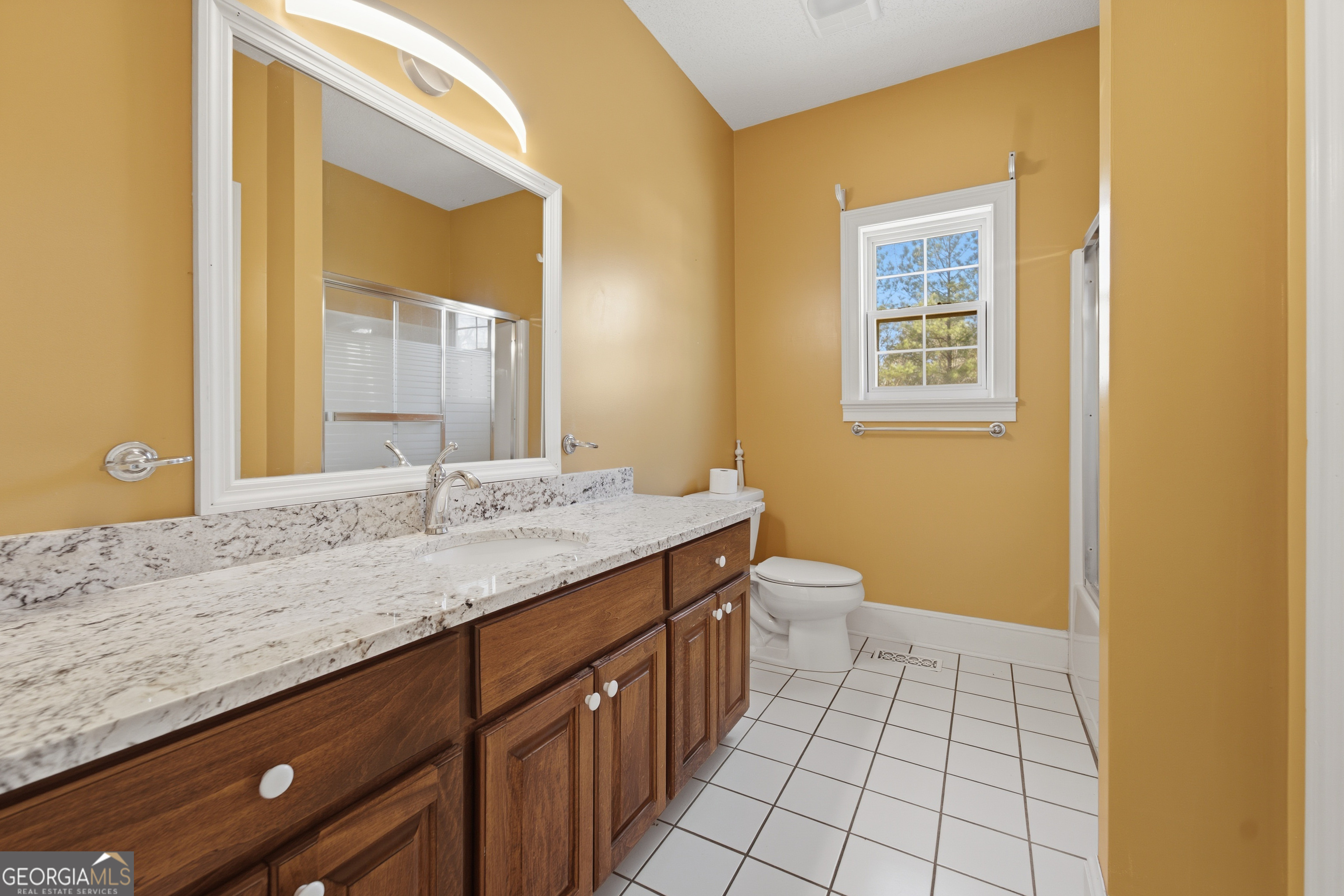134 Patrick Street Swainsboro, GA 30401 - Photo 51 of 57 a bathroom with a granite countertop sink and a mirror