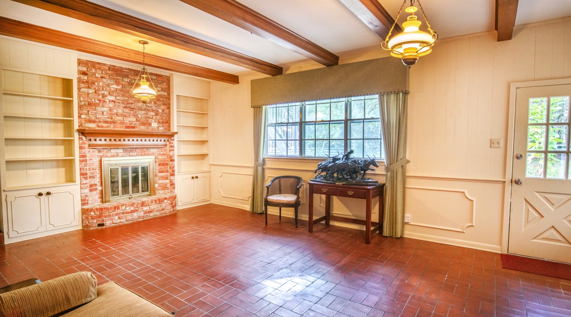 301 Cedar Circle Brenham, TX 77833 - Photo 12 of 20 Entrance foyer featuring brick patterned flooring, beam ceiling, and a brick fireplace