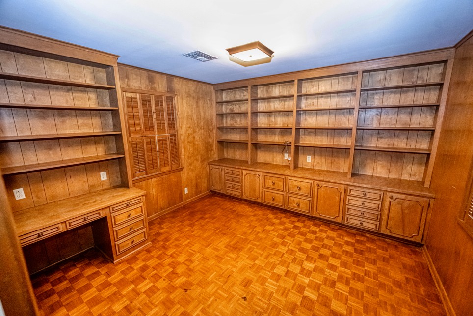 301 Cedar Circle Brenham, TX 77833 - Photo 14 of 20 Unfurnished office featuring built in features, built in desk, and wooden walls