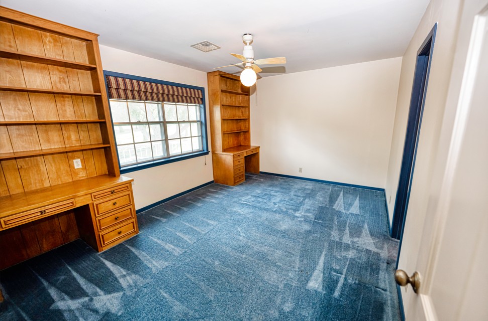 301 Cedar Circle Brenham, TX 77833 - Photo 18 of 20 Unfurnished office with built in desk, dark carpet, and a ceiling fan