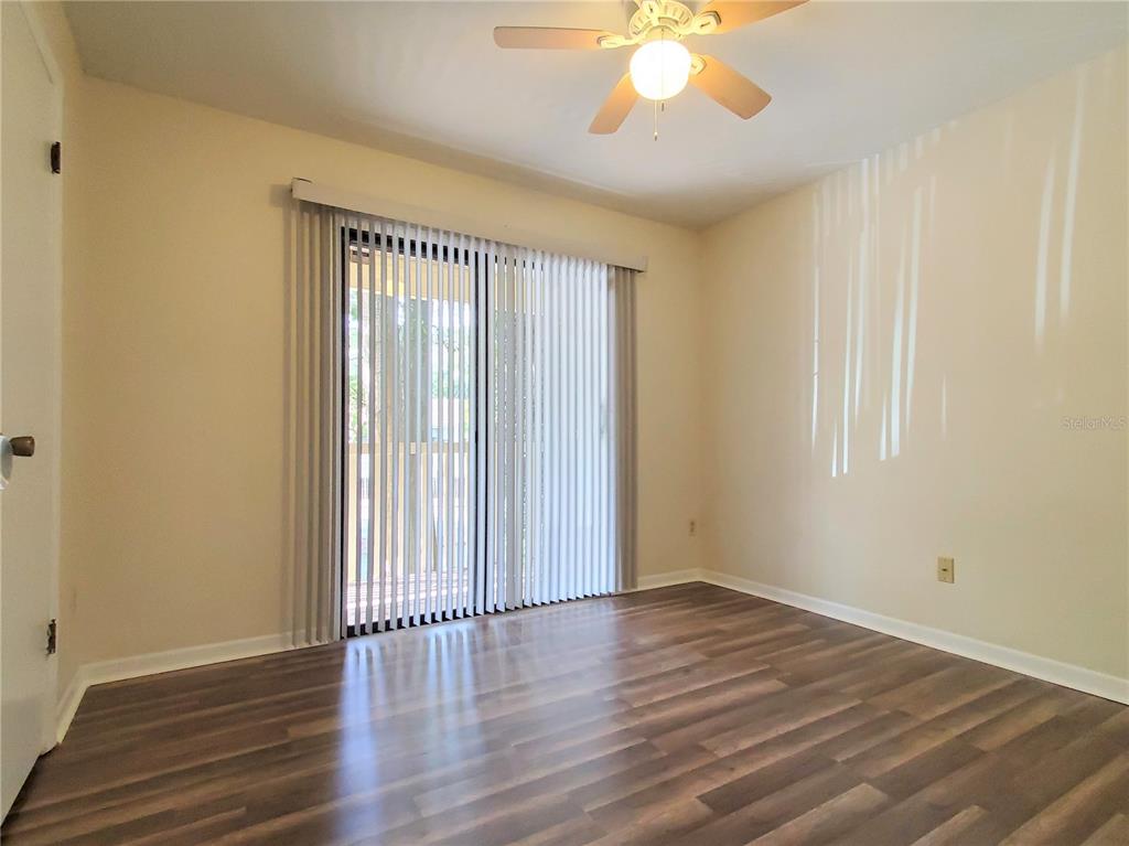2127 Southwest 39 Drive Gainesville, FL 32607 - Photo 12 of 16 a view of an empty room with wooden floor and a window