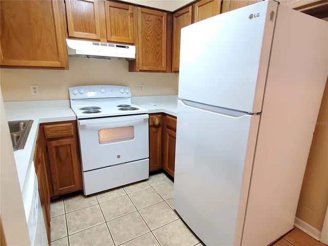 a white refrigerator freezer sitting inside of a kitchen