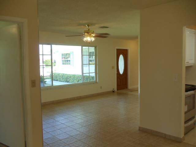 1112 Seagrape Road Lantana, FL 33462 - Photo 7 of 22 a view of a livingroom with a large window closet and chandelier fan