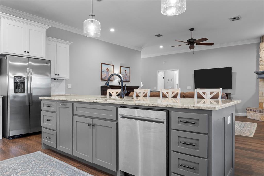 717 Wintergreen Drive Hewitt, TX 76643 - Photo 11 of 33 a kitchen with cabinets a center island and stainless steel appliances