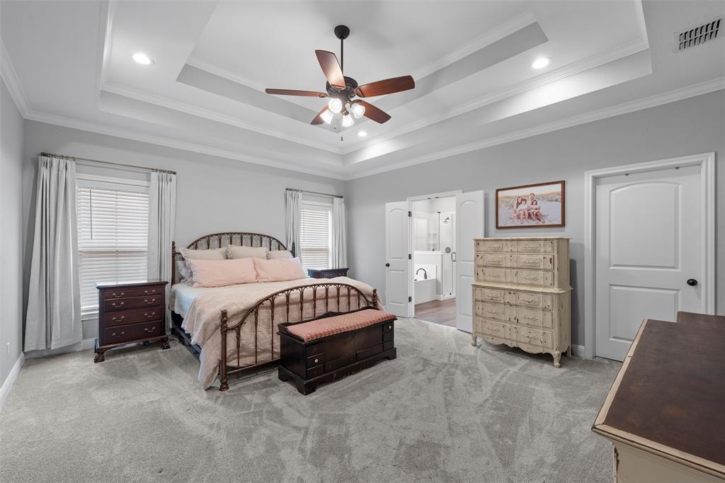 717 Wintergreen Drive Hewitt, TX 76643 - Photo 16 of 33 a bedroom with a bed and a chandelier