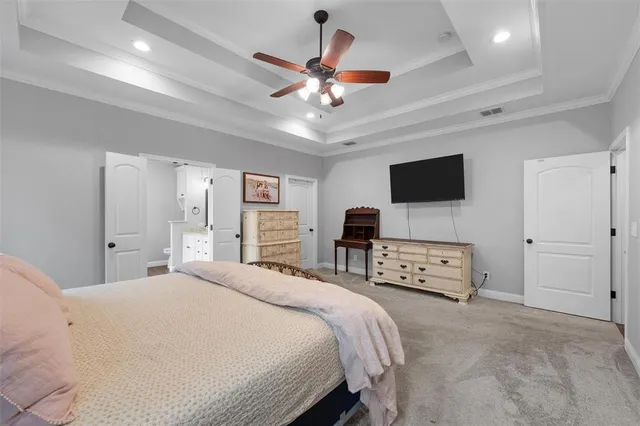 a bedroom with a bed window and a flat screen tv