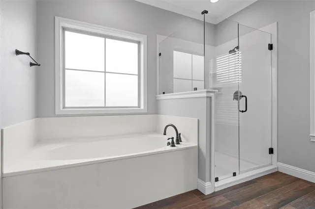 a white bath tub sitting next to a shower