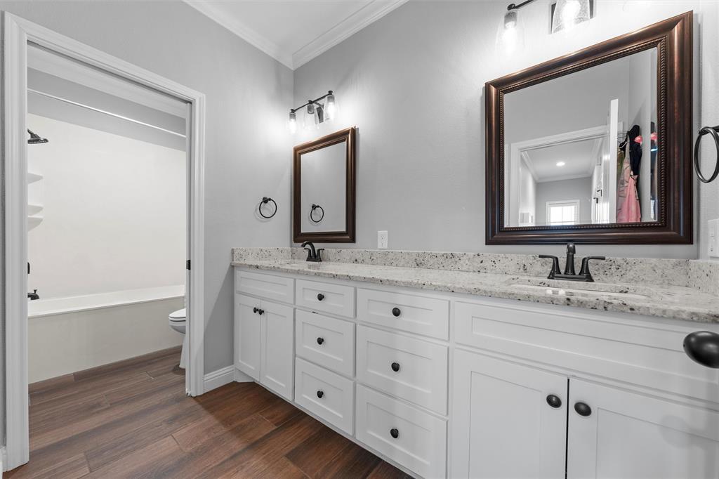 717 Wintergreen Drive Hewitt, TX 76643 - Photo 22 of 33 a bathroom with double vanity sink two mirror and a