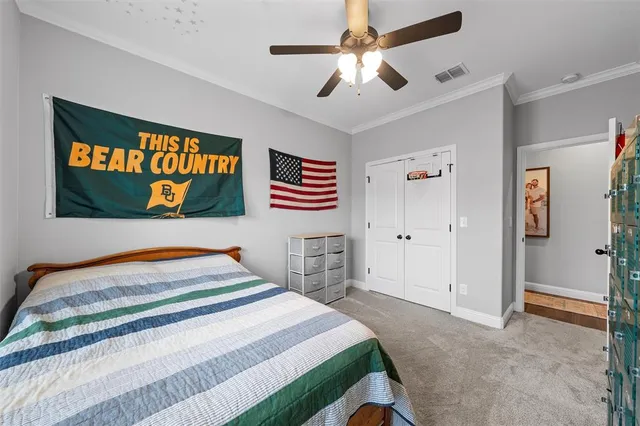 a bedroom with a bed and a chandelier