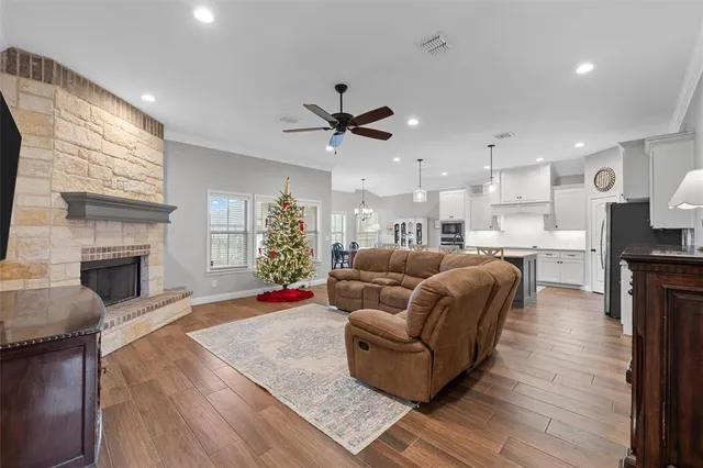 a living room with furniture fireplace and kitchen view