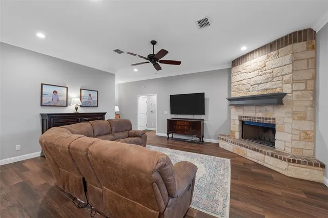 a living room with furniture a fireplace and a flat screen tv