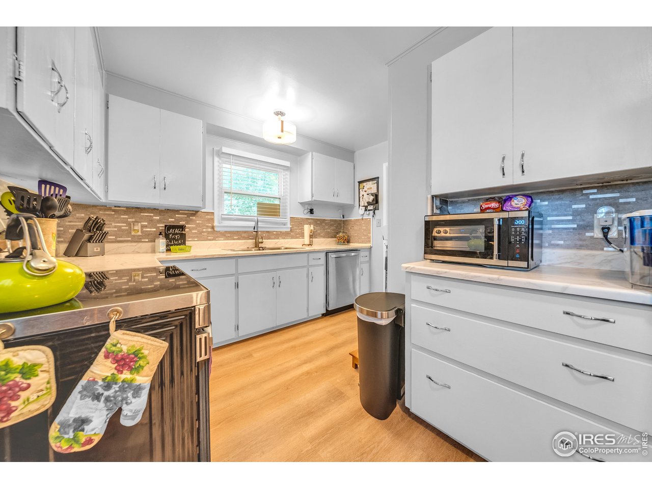714 Delmar Street Sterling, CO 80751 - Photo 9 of 22 a kitchen with cabinets and appliances