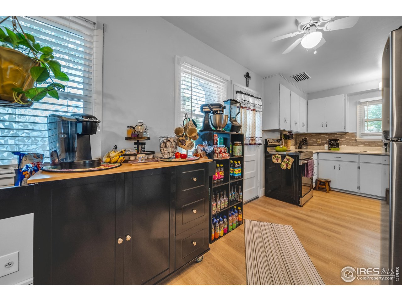 714 Delmar Street Sterling, CO 80751 - Photo 10 of 22 a open kitchen with stainless steel appliances granite countertop a refrigerator a sink dishwasher a dining table and chairs with wooden floor