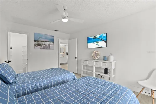 a bedroom with a bed and a desk