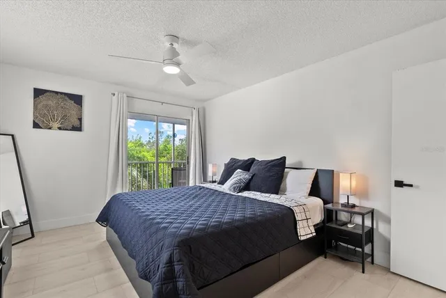 a bed sitting in a bedroom next to a window