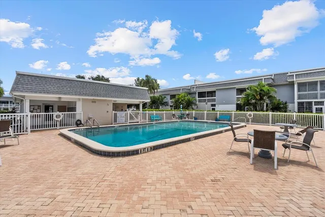 a swimming pool with outdoor seating and yard