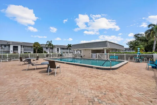 a view of a swimming pool with a lounge chair