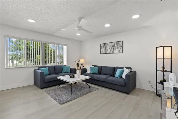 a living room with furniture and a large window