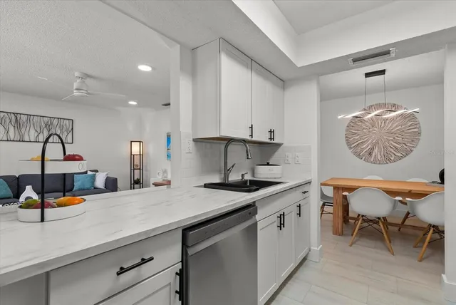 a kitchen with a sink cabinets and window