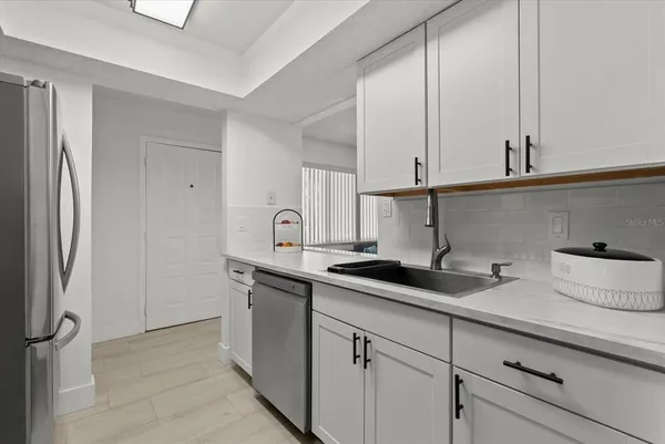 a kitchen with stainless steel appliances a sink and cabinets