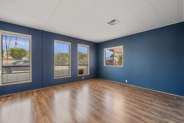 a living room with a couch and wooden floor