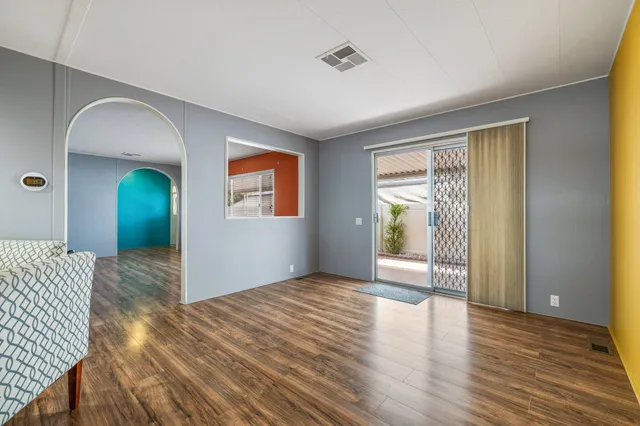 a large kitchen with granite countertop a large window and white appliances