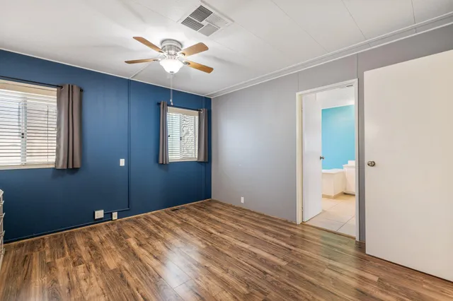 a view of a room with wooden floor and a window