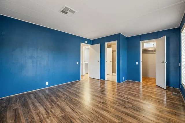 a room that has a bed and a chandelier fan