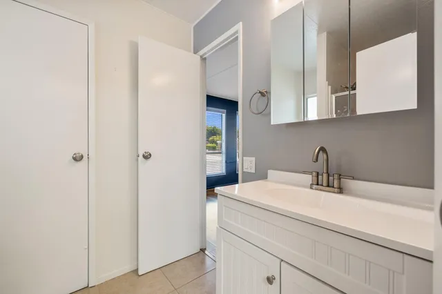 a bathroom with a sink a vanity and a mirror