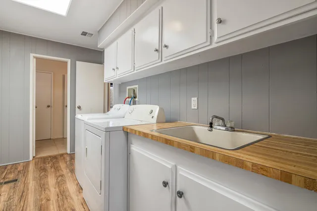 a utility room with cabinets washer and dryer