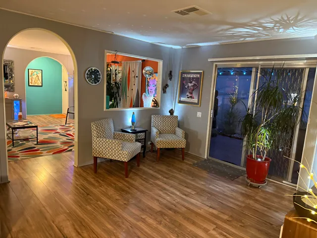 a living room with furniture and a wooden floor