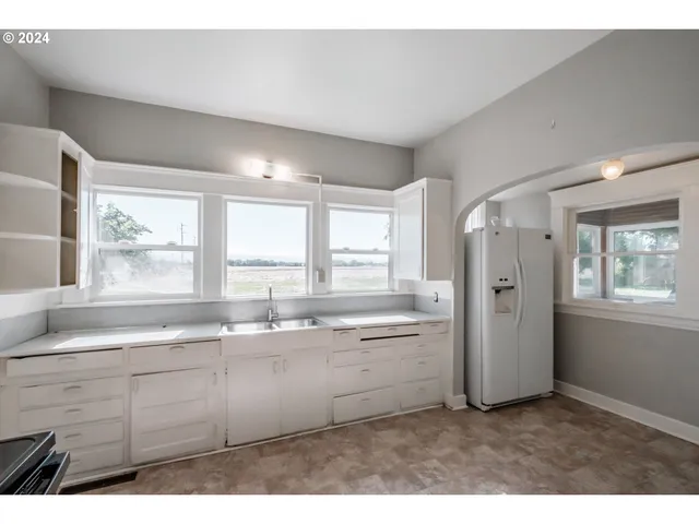 a kitchen with a sink cabinets and window