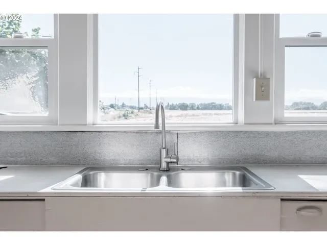 a kitchen with a sink and a window