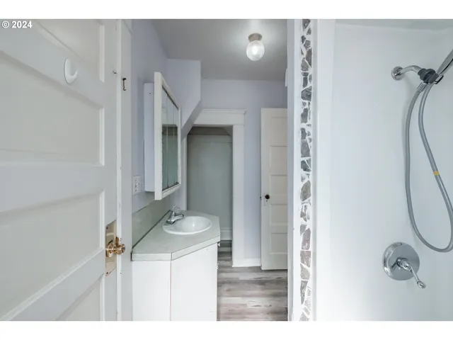 a bathroom with a sink a mirror and shower