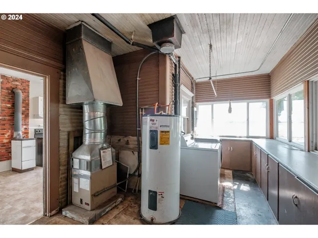 a kitchen with stainless steel appliances kitchen island granite countertop a refrigerator and microwave