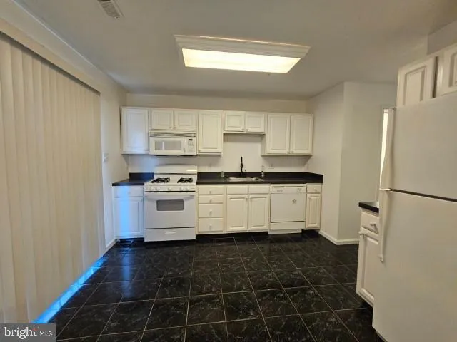 a bathroom with a sink toilet and a mirror