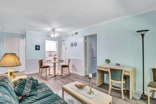 a living room with furniture a chandelier and a window