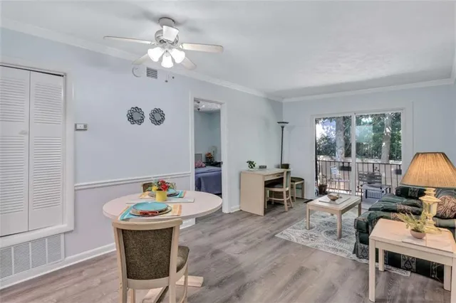 a living room with furniture a dining table and a chandelier