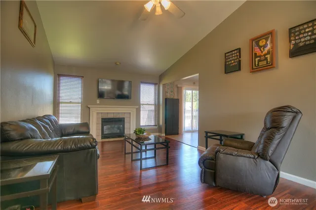 a living room with furniture a fireplace and a flat screen tv