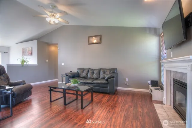 a dining room with wooden floor a chandelier a wooden table and chairs