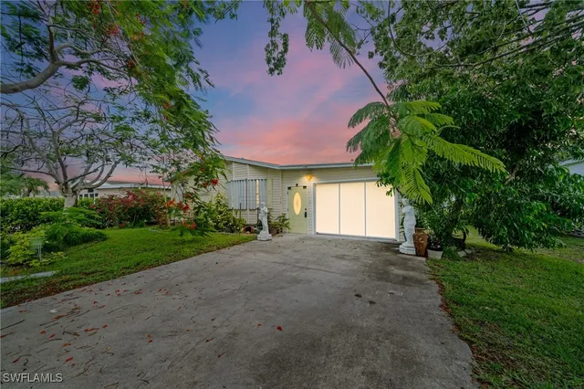 a view of a house with a yard and garage