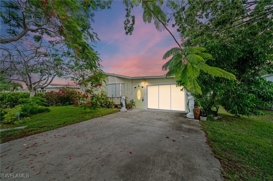 a view of a house with a yard and garage