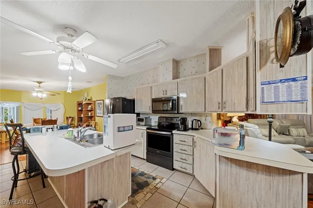 a kitchen with a sink a stove and cabinets