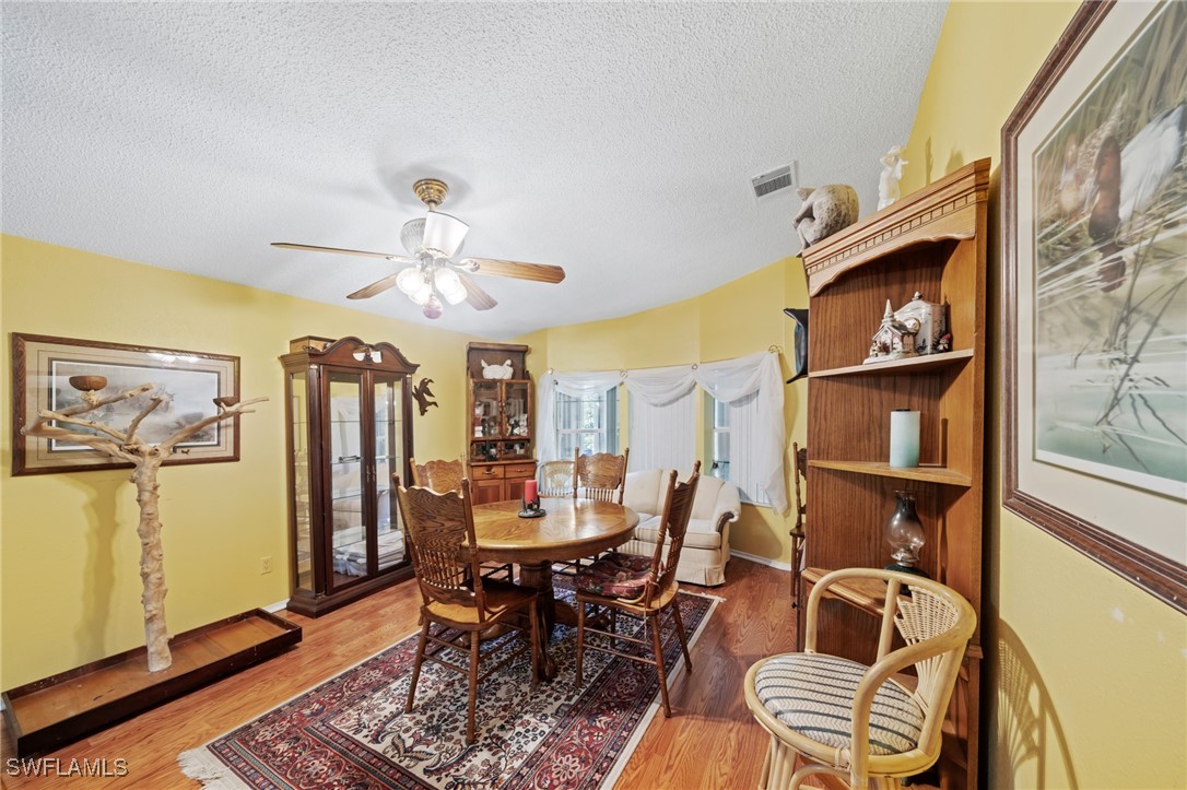 919 Manatee Road Naples, FL 34114 - Photo 14 of 32 a view of a dining room with furniture and chandelier