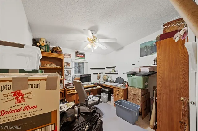 a workspace with furniture and ceiling fan