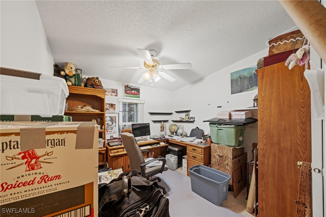 919 Manatee Road Naples, FL 34114 - Photo 16 of 32 a workspace with furniture and ceiling fan
