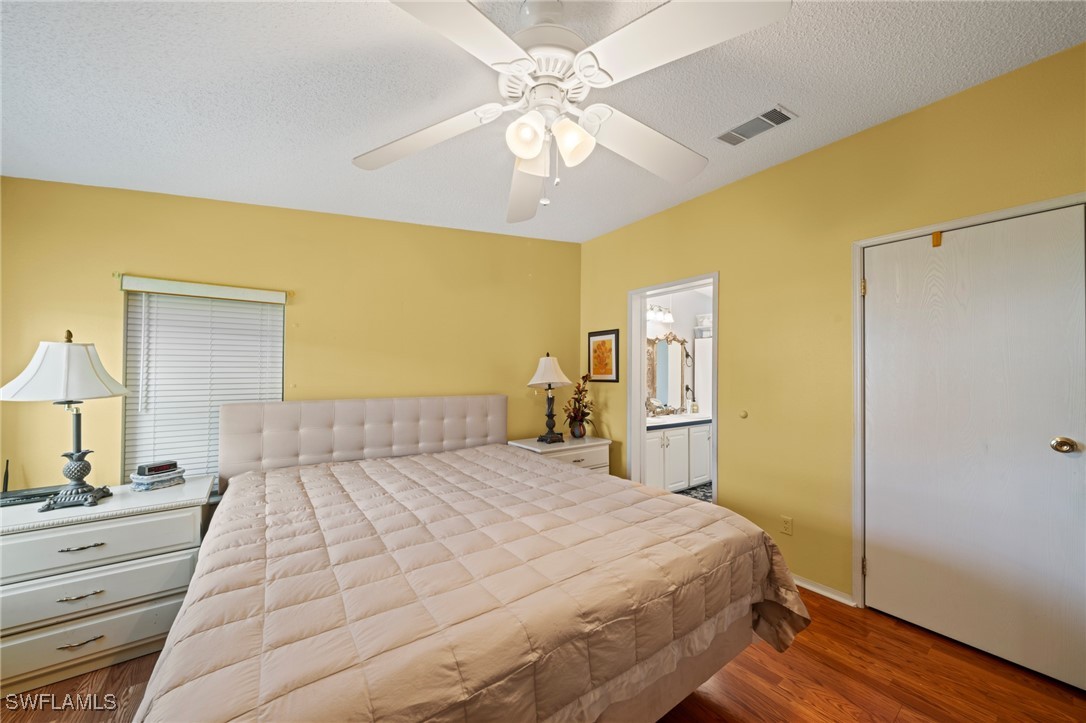 919 Manatee Road Naples, FL 34114 - Photo 18 of 32 a bedroom with a bed and a chandelier