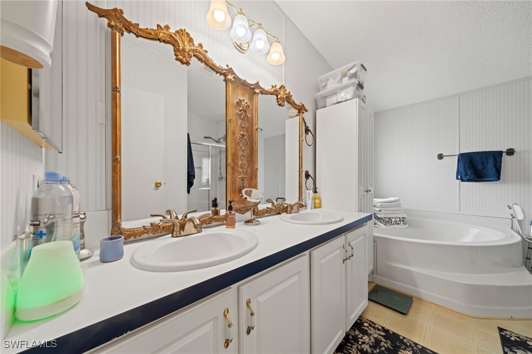 919 Manatee Road Naples, FL 34114 - Photo 19 of 32 a bathroom with a sink double vanity and a mirror