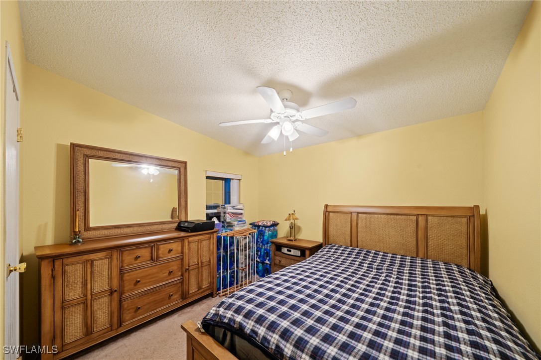 919 Manatee Road Naples, FL 34114 - Photo 20 of 32 a bedroom with a bed and wooden floor